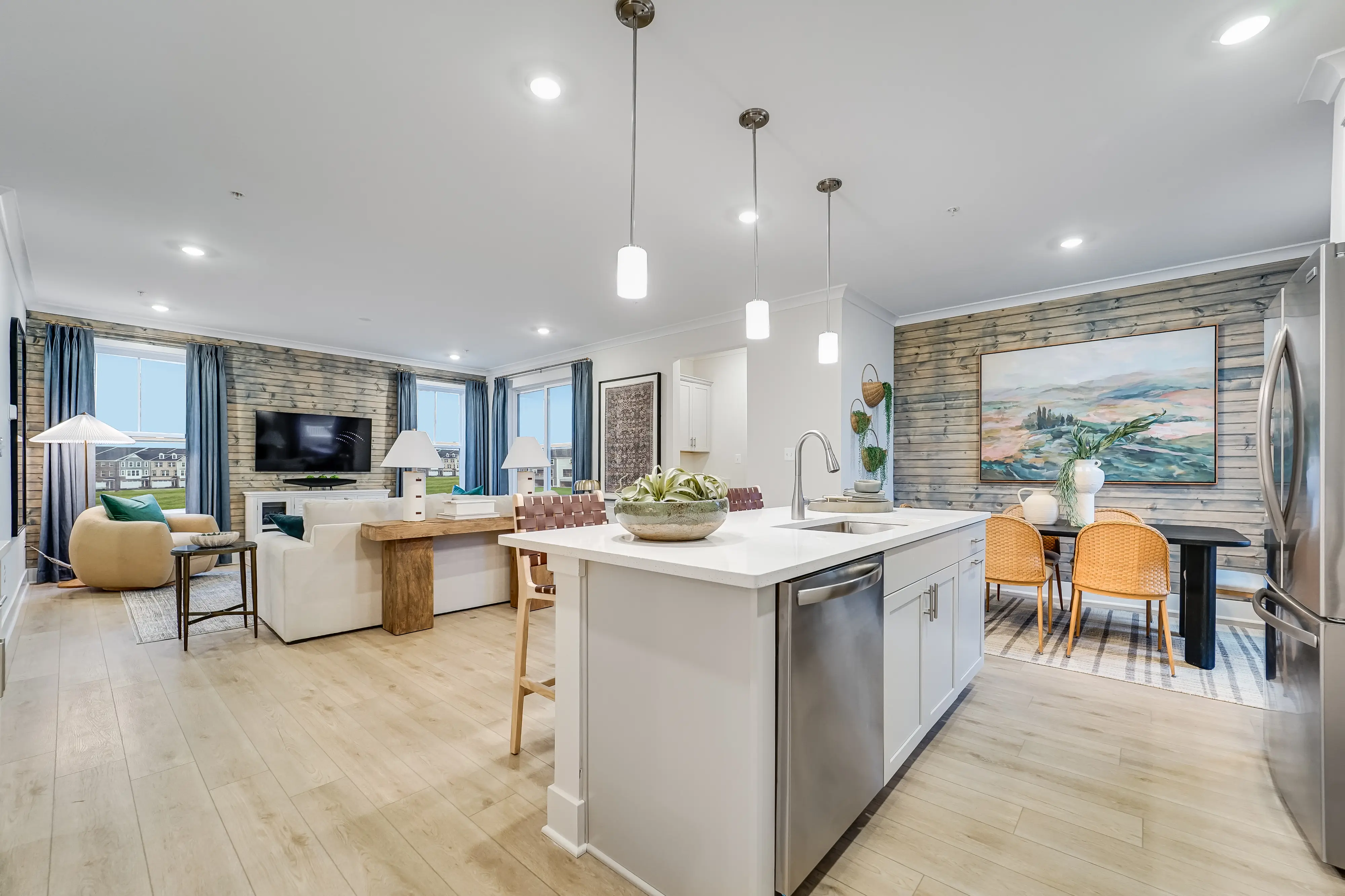 Shiny kitchen island and open living space to show what the interior of the homes in Baltimore County MD at Greenleigh by Lennar Homes look like