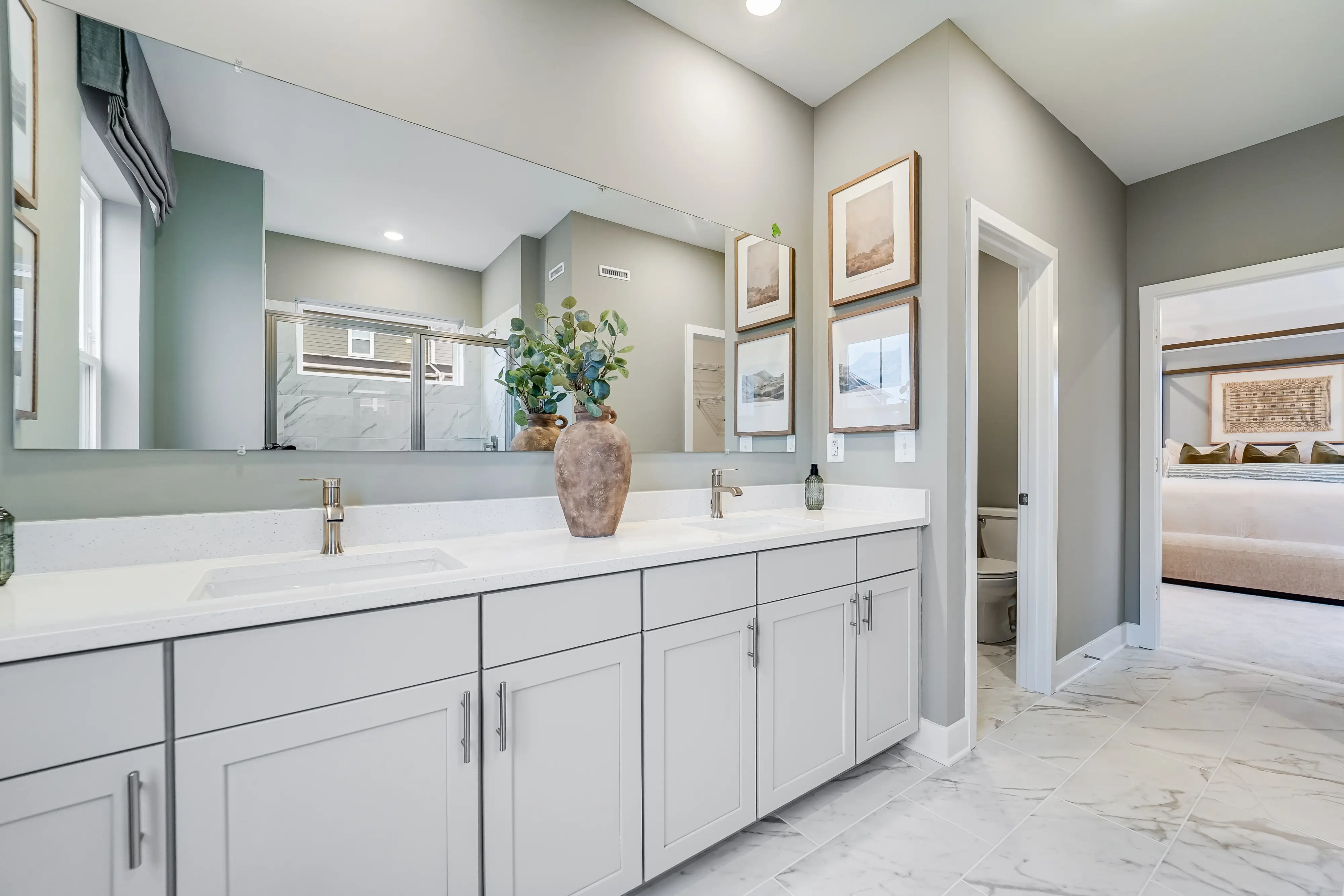 A shiny row of new bathroom cabinets with his and her sinks