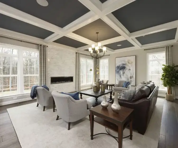 Living room featuring coffered ceilings in Williamsburg Home at Greenleigh